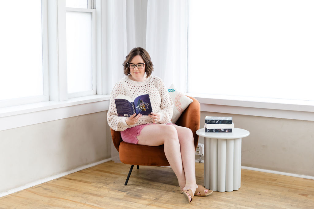 Mobile bookstore owner Sara Gillis reading a book in Sioux Falls